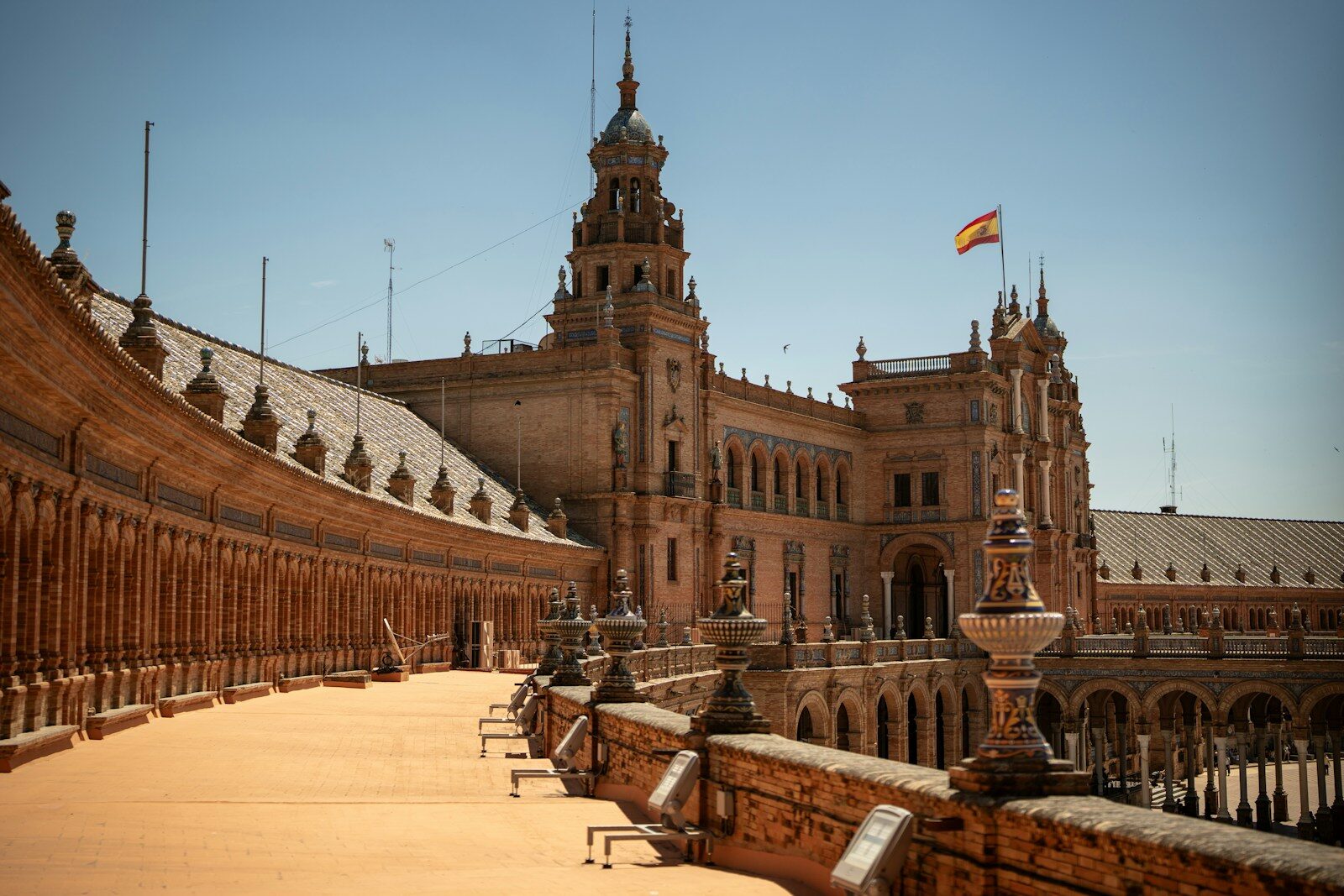 The Plaza de España in Seville with its ornate brick architecture and Spanish flag
